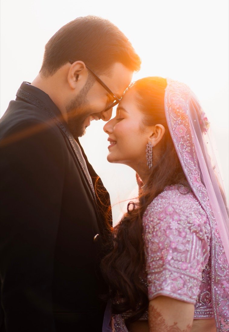 A couple forehead to forehead in warm evening backlight