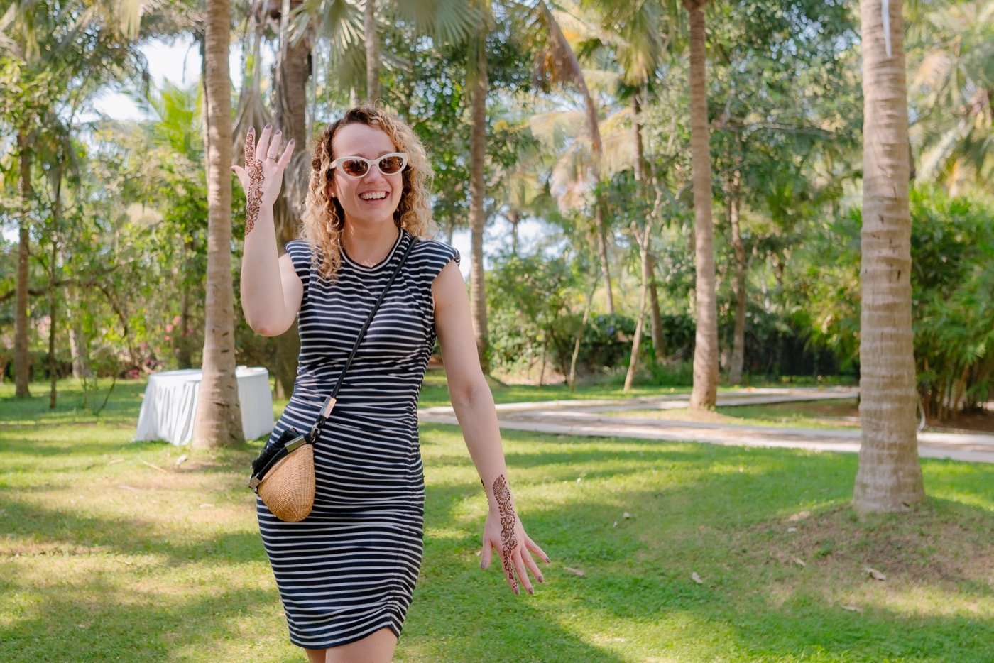 A guest waving across a palm garden
