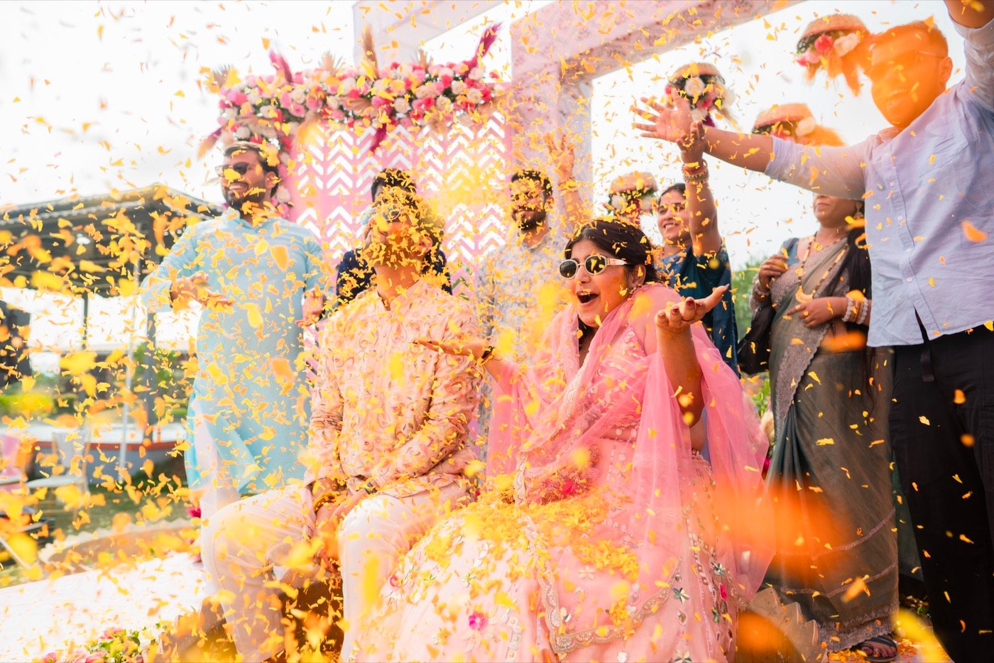 Guests throwing petals over the couple at the haldi