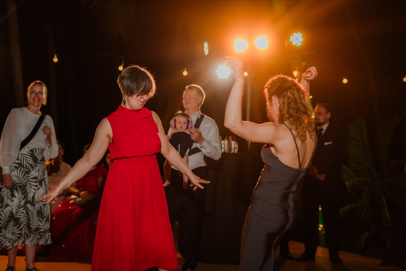 Guests dancing under warm stage lights