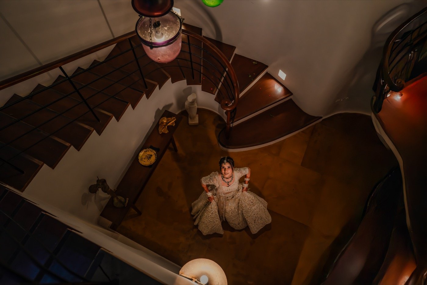 A bride seen from above on a spiral staircase