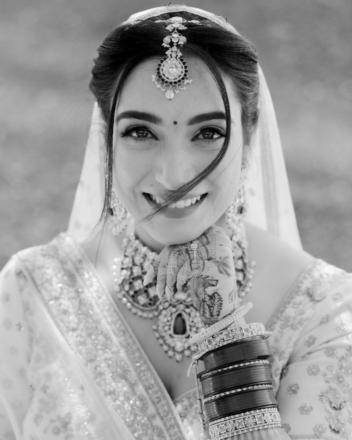 A high-contrast black and white portrait of Shivani on her wedding day